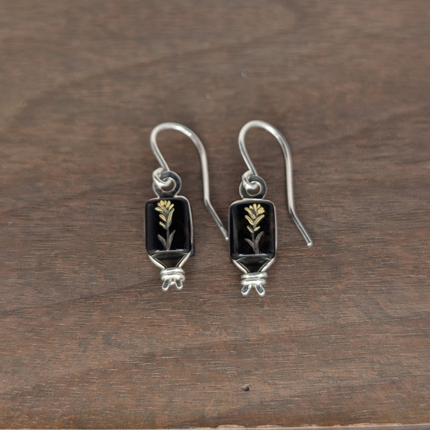 Pair of silver earrings with hand oil painted image of yellow flower on utah obsidian